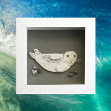 Load image into Gallery viewer, A framed shadow box art piece featuring a handcrafted seal on a gray background, set against an ocean wave backdrop.