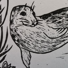 Load image into Gallery viewer, A close up photograph of a linocut of a seal called Arrowhead, made by printmaking artist Holly Dominique